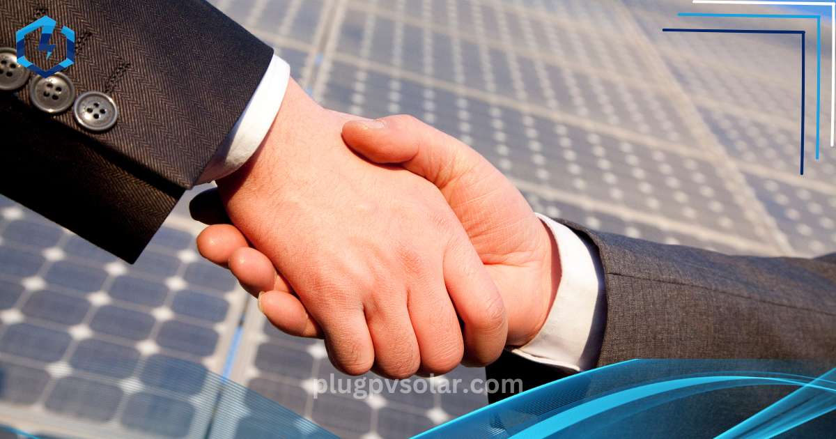 two people shaking hands in front of solar panels
